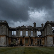Clandon Park's ruined structure against a dramatic sky.