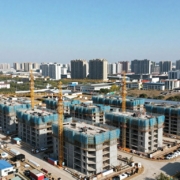New housing developments under construction near a city.