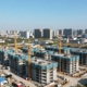 New housing developments under construction near a city.